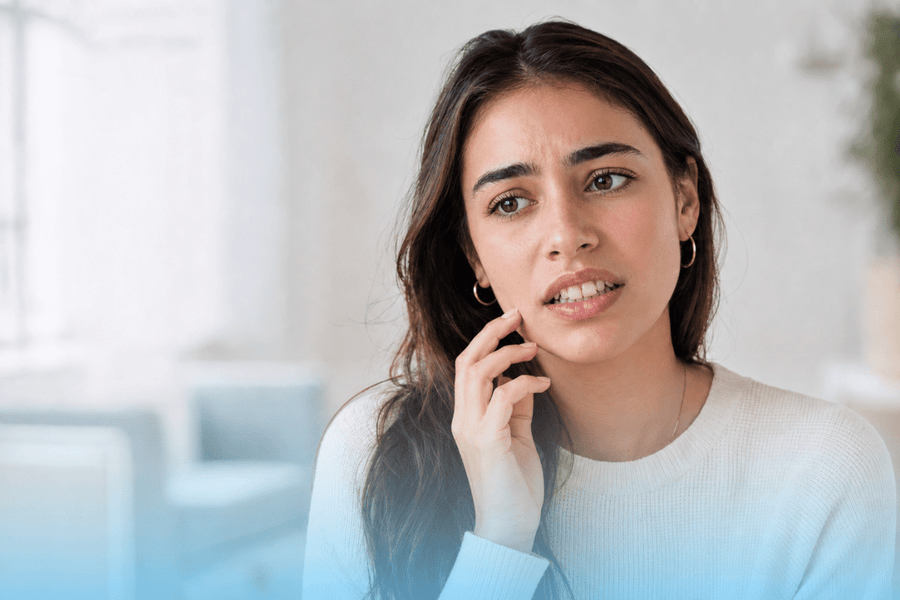 Young woman showing concern about teeth crowding and bite alignment