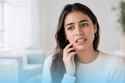 Young woman showing concern about teeth crowding and bite alignment