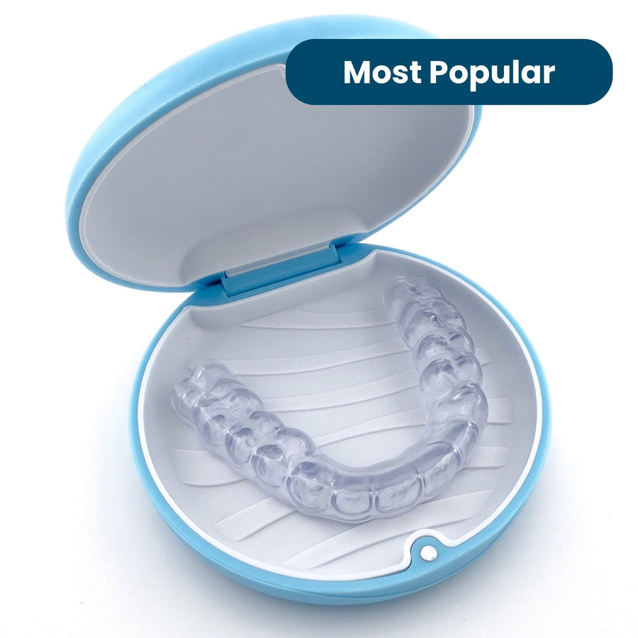 Hybrid Night Guard for Teeth Grinding sitting in blue retainer case from SayCheeseClub