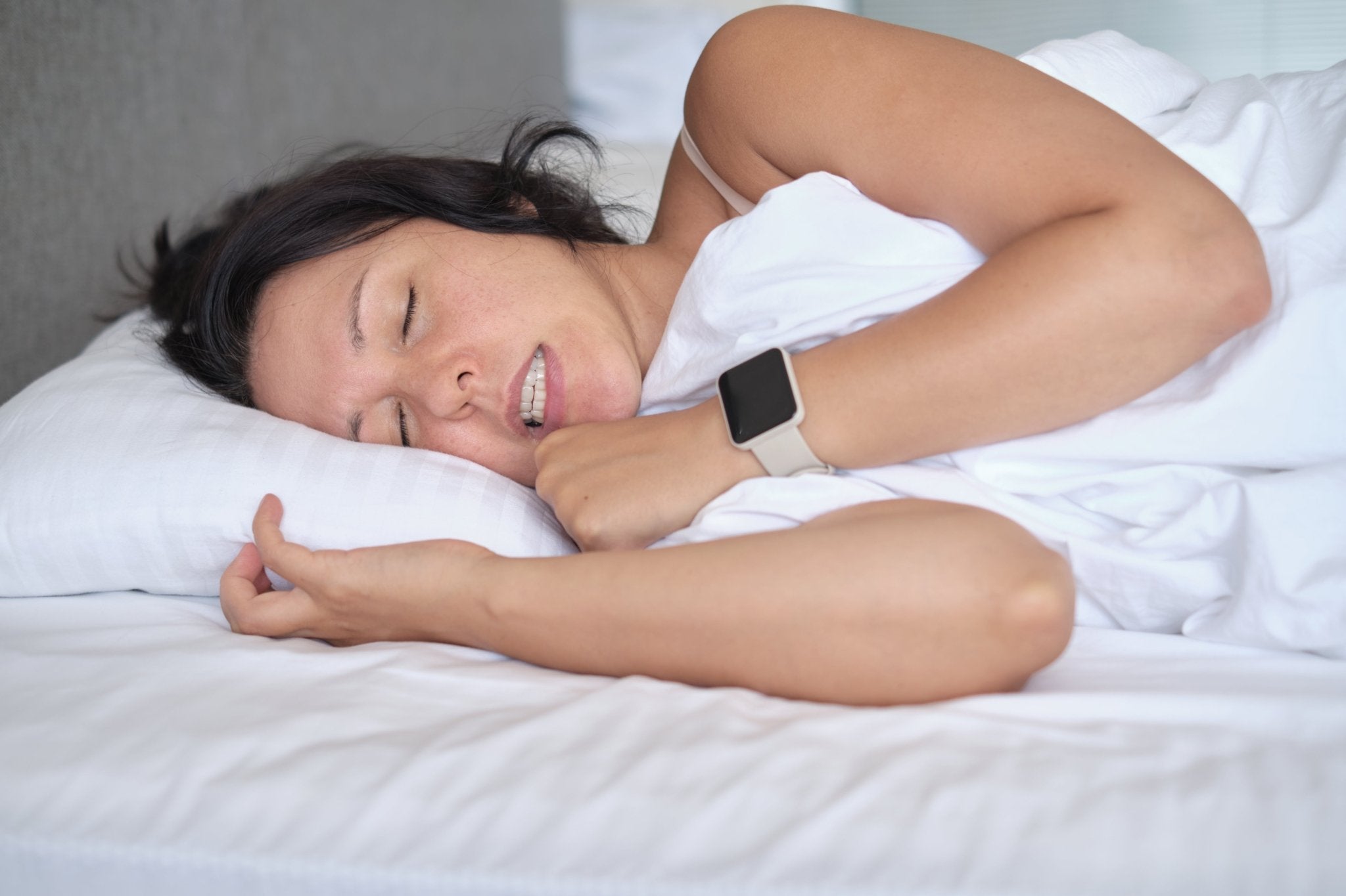 Woman_Laying_Down_Grinding_Teeth
