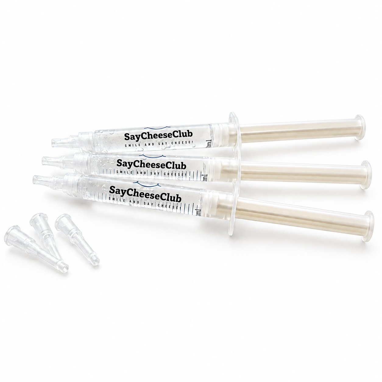 Three clear plastic syringes labeled SayCheeseClub Whitening Gel, with three small clear applicator tips placed beside them on a white background.