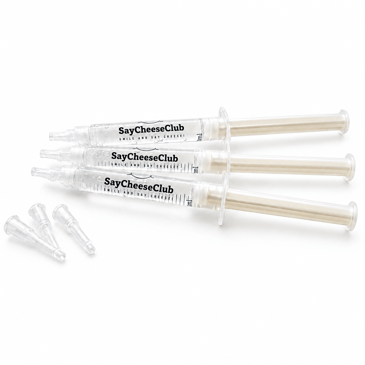 Three clear plastic syringes labeled SayCheeseClub Whitening Gel, with three small clear applicator tips placed beside them on a white background.
