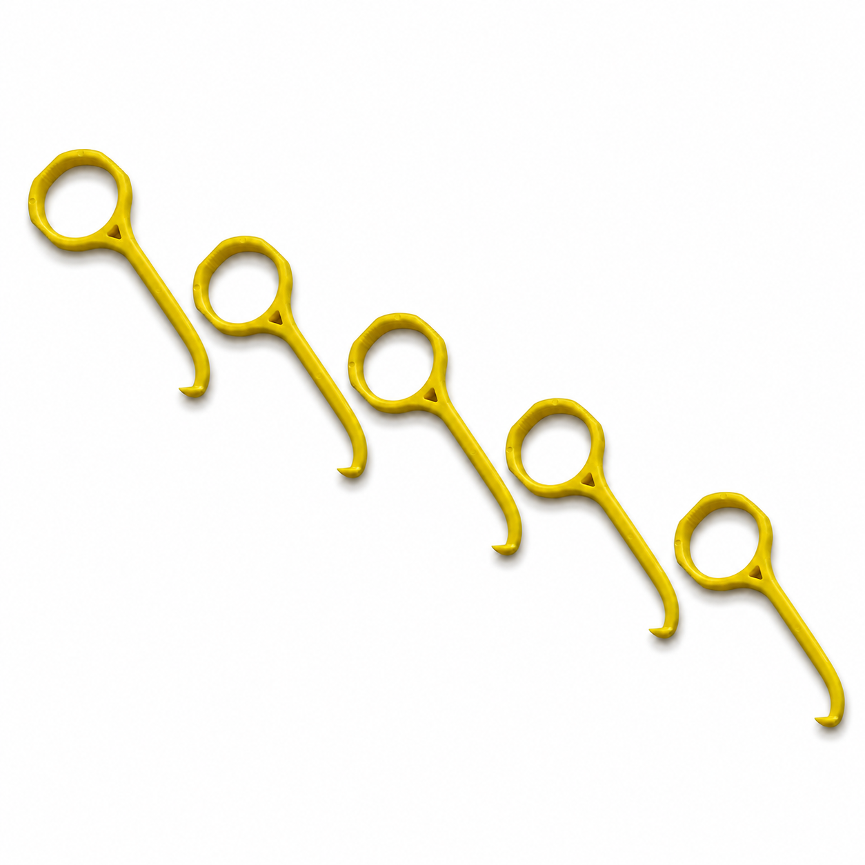 Five bright yellow plastic aligner removal tools arranged diagonally on a plain white background