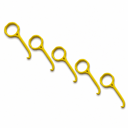 Five bright yellow plastic aligner removal tools arranged diagonally on a plain white background