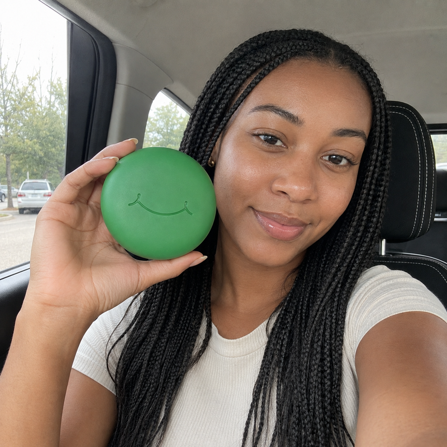 A woman holds a green SayCheeseClub case