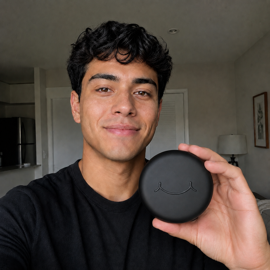 A black SayCheeseClub case held in one hand