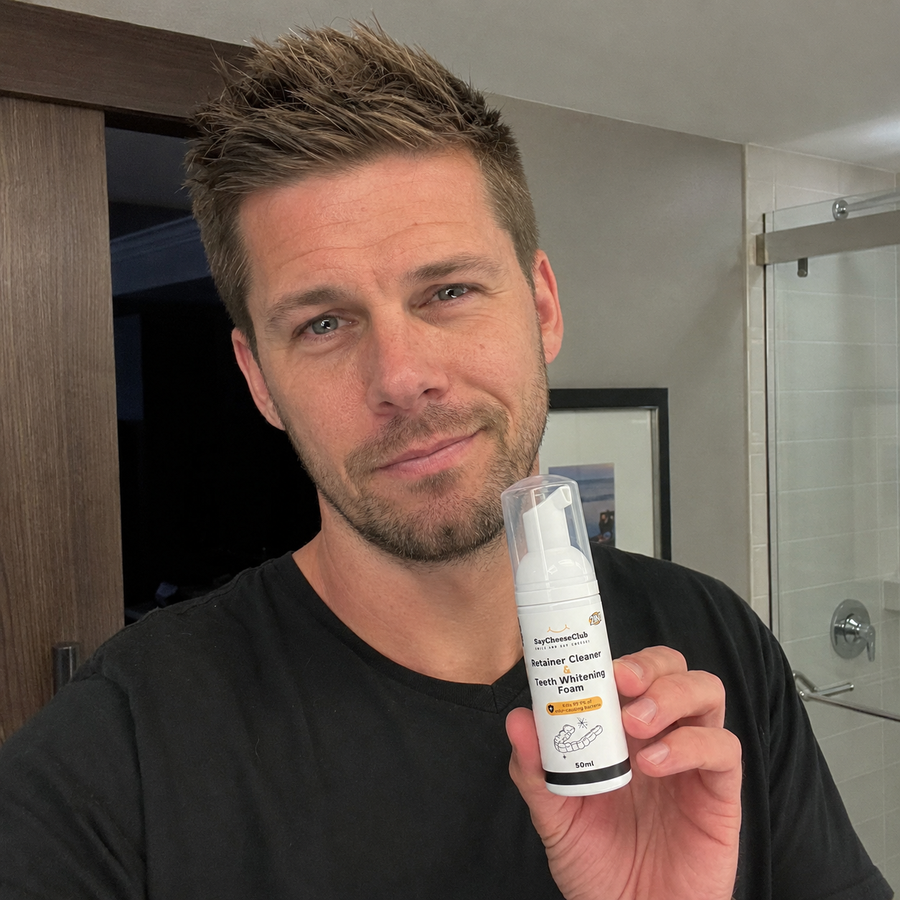 Man holding SayCheeseClub Cleaner and Whitening Foam