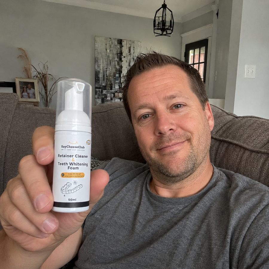 Man showing the SayCheeseClub foam bottle