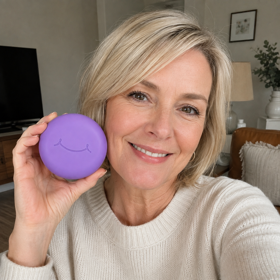 A woman holds a purple SayCheeseClub case