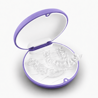 A set of clear transparent dental aligners displayed inside an open round case with a purple rim and white interior, on a clean white background.