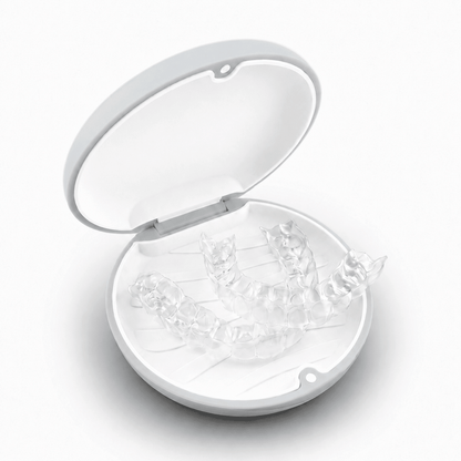 A round white hard retainer case with a simple embossed smiley face on top, photographed on a clean white background.  Also good for clear aligner case.