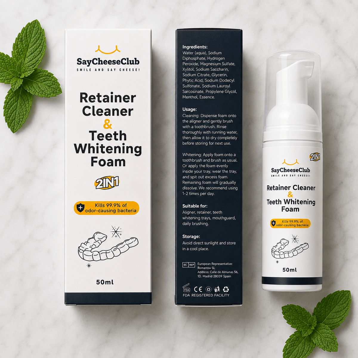 A 2-in-1 Retainer Cleaner & Teeth Whitening Foam set by SayCheeseClub, shown with its white and navy packaging boxes and a white pump bottle on a light marble background with mint leaves.