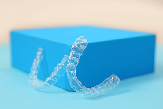 Custom upper and lower clear retainer set by SayCheeseClub to prevent teeth from shifting, made from FDA-approved, BPA-free materials.