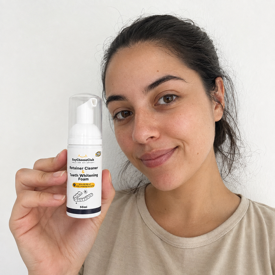 Woman showing SayCheeseClub Cleaner and Whitening Foam