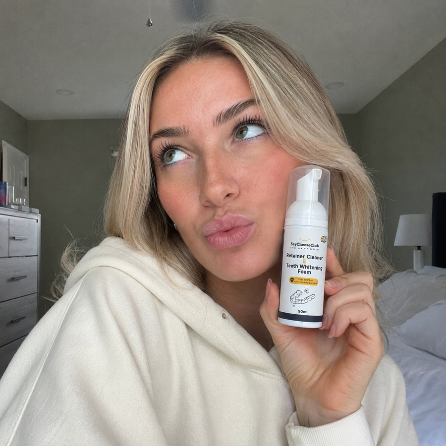 Woman holding SayCheeseClub Cleaner and Whitening Foam