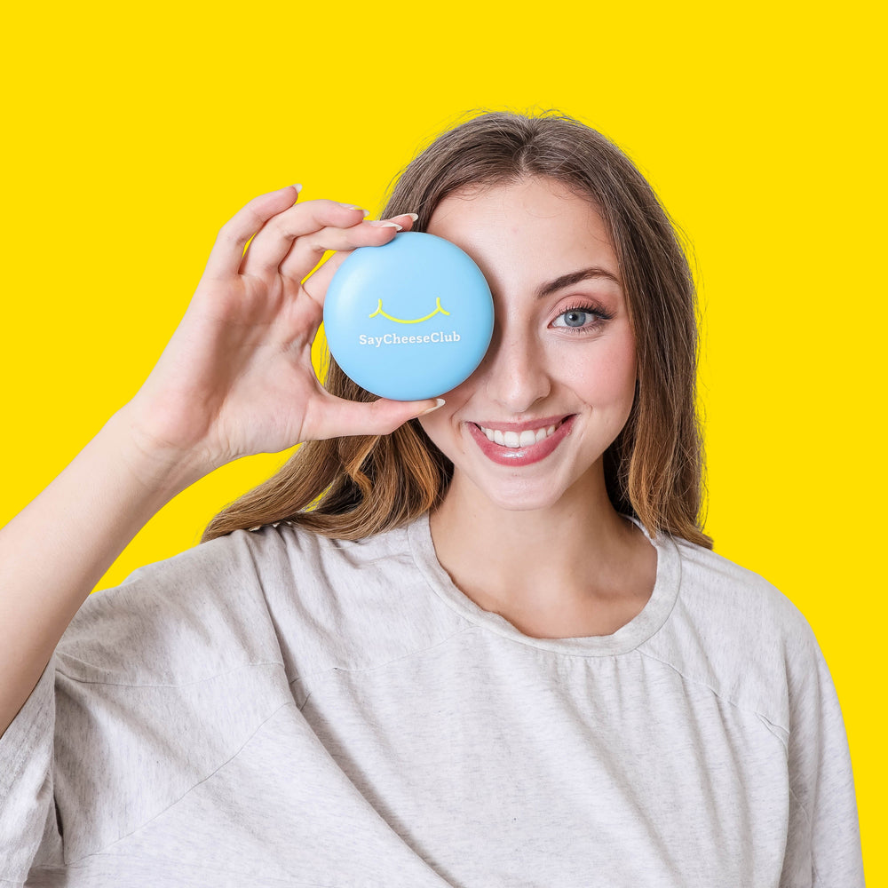 Woman holding a blue SayCheeseClub case