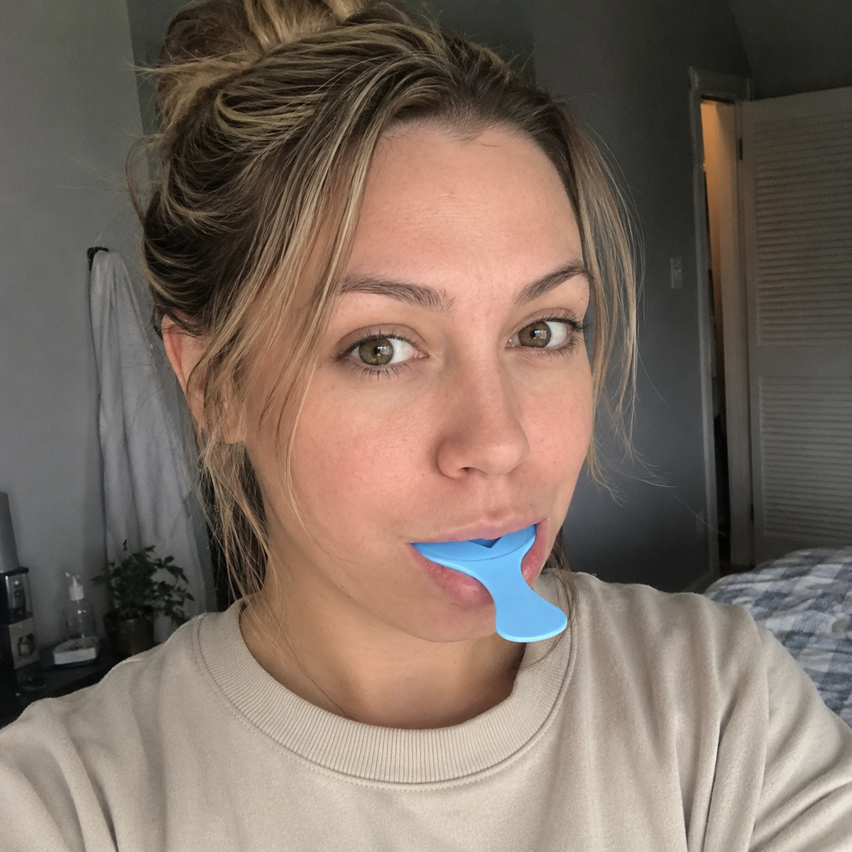 Woman taking her dental impressions at home with the SayCheeseClub kit
