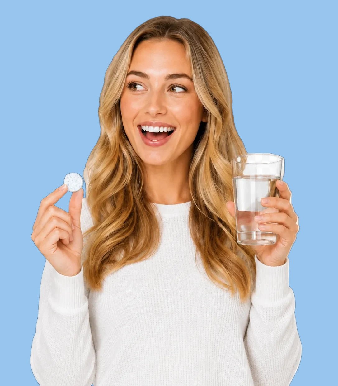 A woman with long blonde hair smiles while holding a small white round tablet in one hand and a glass of water in the other, set against a solid light blue background.