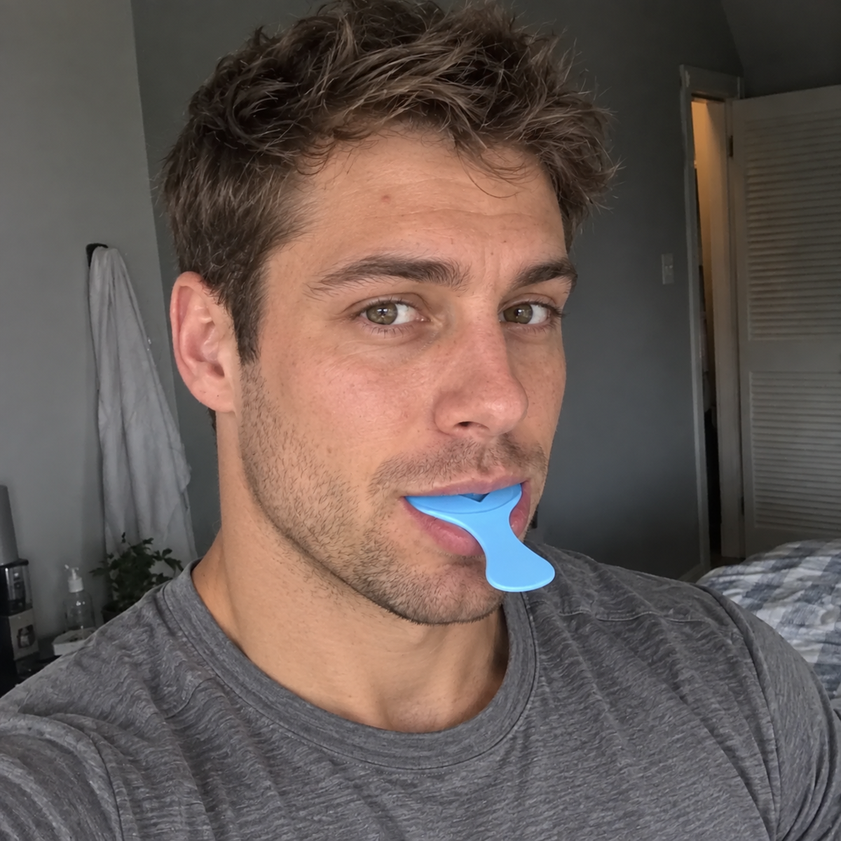 Man taking a dental impression with a blue SayCheeseClub tray
